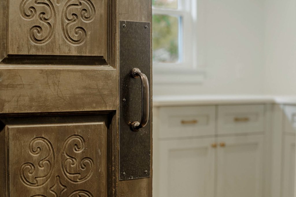 vintage wooden carved door and white custom cabinets|Phase One