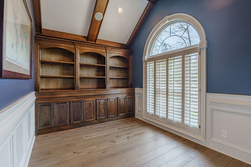 Built in shelves and wood floor with a large window